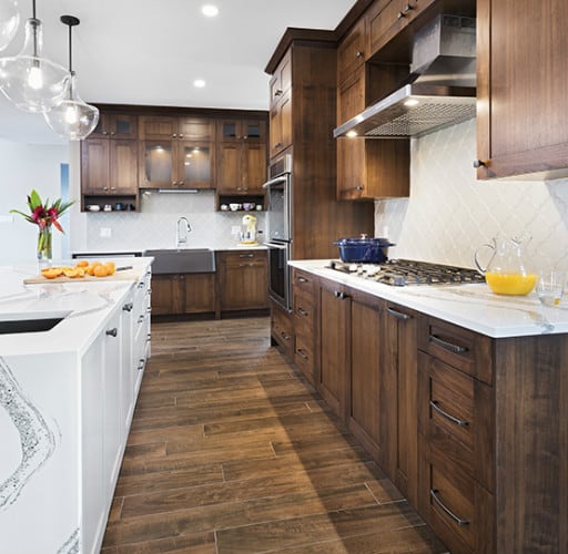 Wood cabinets with white marbled island